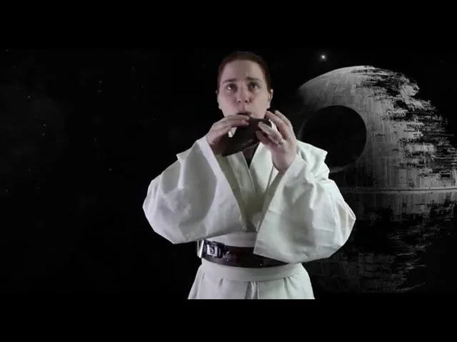 Clickable Video. A picture of Lydia playing the ocarina in a Star Wars Jedi outfit.