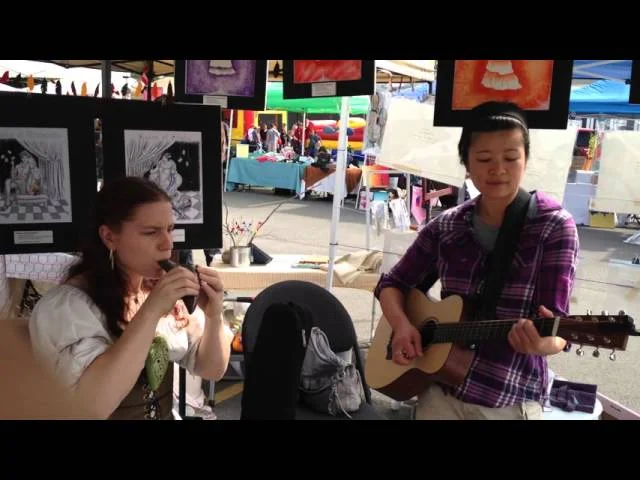 Clickable Video. A picture of Lydia playing with another musician.